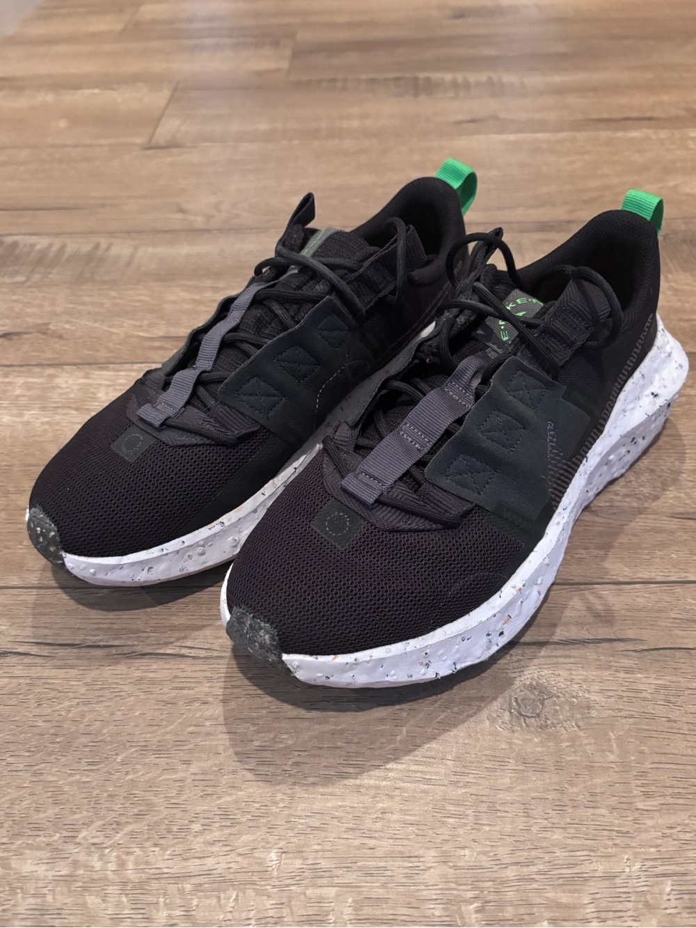 Nike Black Sneakers with White Speckled Sole and Green Pull Tabs